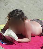 Topless girl reads a book