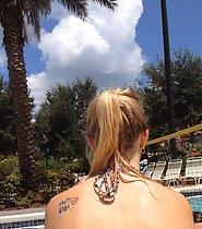 Tattooed cutie at swimming pool