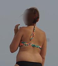 Chubby girl walks on beach