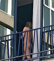 Nude girl on the balcony
