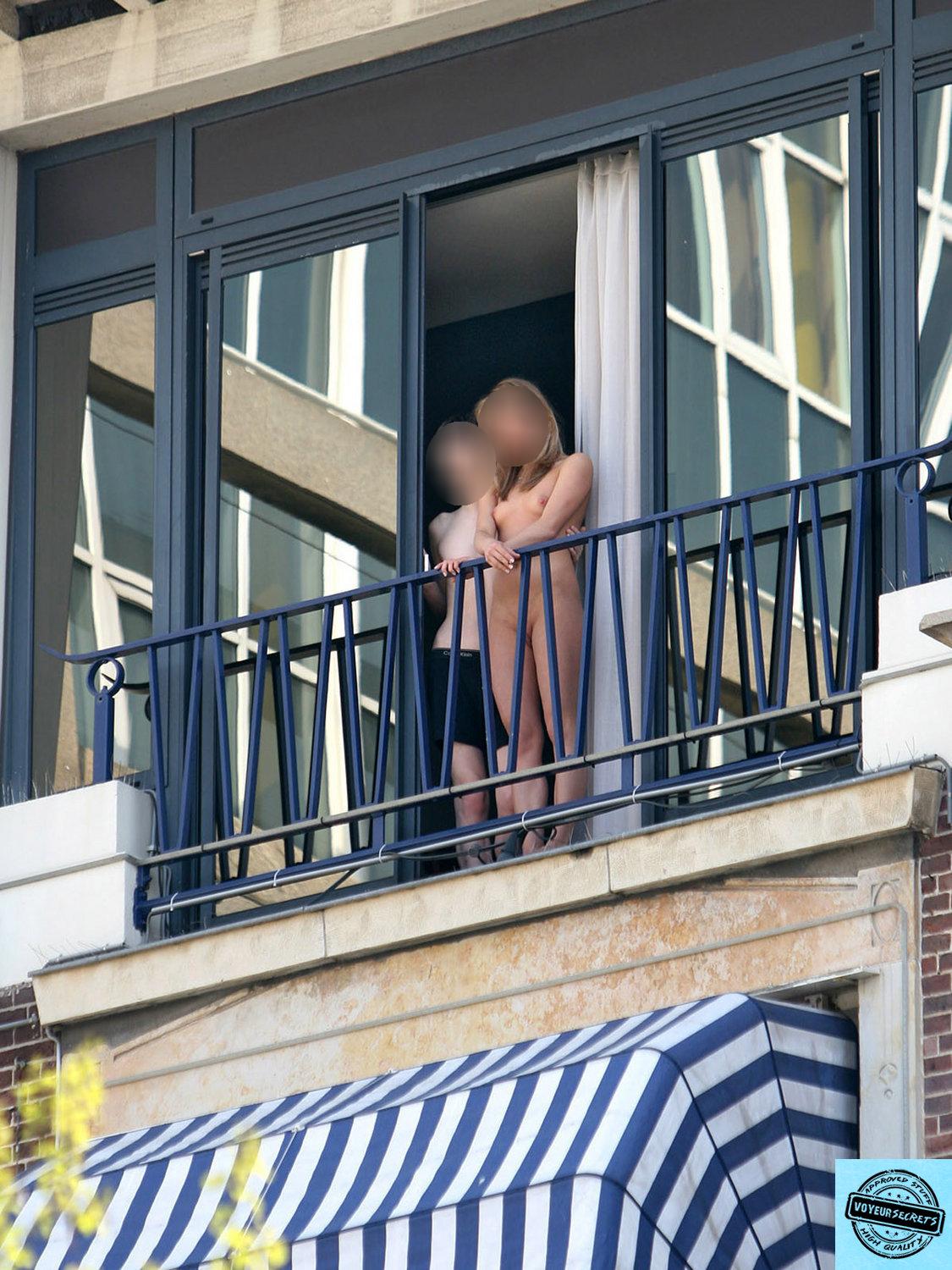 Nude girl on the balcony photo