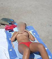 Woman tans in topless