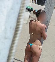 Hot girl removes her bikini top on beach