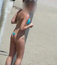 Hot girl removes her bikini top on beach