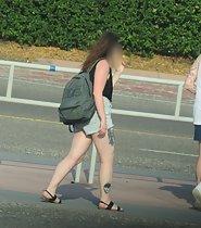 Tattooed girl spreads legs in shorts