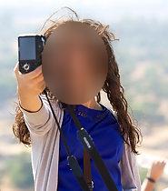 Adorable tourist girl makes selfies