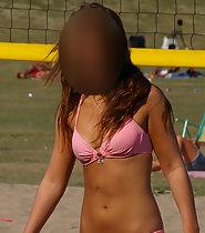 Gorgeous girl plays beach volleyball