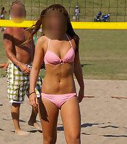 Gorgeous girl plays beach volleyball