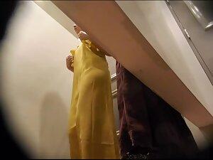 Checking her naked tits while she tries out classy dresses Picture 1