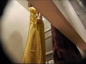 Checking her naked tits while she tries out classy dresses Picture 2