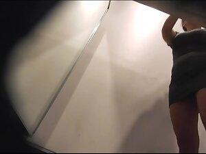 She takes off panties while trying out a tight dress Picture 1