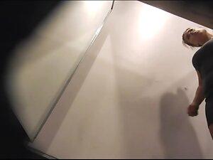 She takes off panties while trying out a tight dress Picture 2