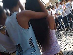 Teen girls hug while watching parade