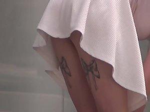Quick upskirt of girl with tattooed ribbons on her thighs Picture 8