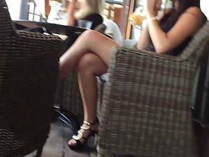 Charming girl sits with crossed legs in a coffee bar Picture 1