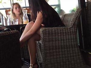 Charming girl sits with crossed legs in a coffee bar Picture 3