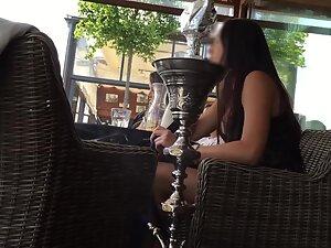Charming girl sits with crossed legs in a coffee bar Picture 6