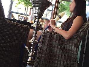 Charming girl sits with crossed legs in a coffee bar Picture 8