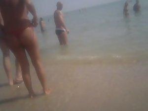 Topless girl in a red thong Picture 3