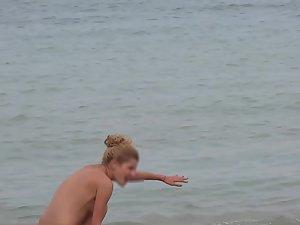 Petite nudist girl washes her ass from the sand Picture 7