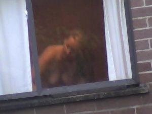 Mature woman changes by the window Picture 4