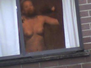 Mature woman changes by the window Picture 6