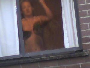 Mature woman changes by the window Picture 7