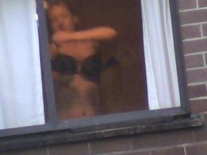 Mature woman changes by the window Picture 8