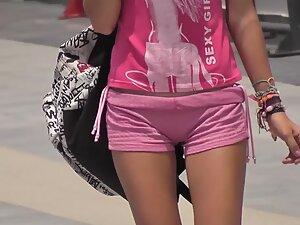 Pink shorts show a trace of cameltoe