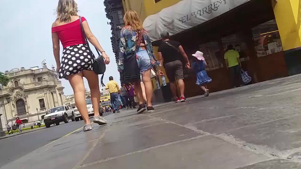 Her red skirt attracts attention of upskirt voyeur guy