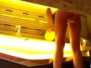 Naked woman in the tanning saloon