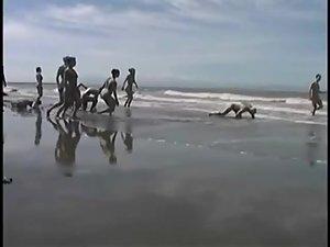 Bunch of nudists exercising on the beach Picture 3