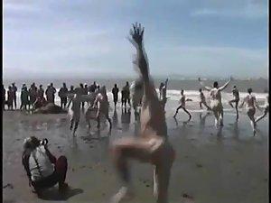 Bunch of nudists exercising on the beach Picture 7