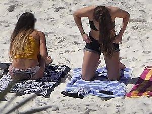 Two sexy girls removing their shorts on beach Picture 8