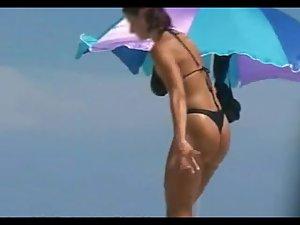 Woman removes her bikini on a beach Picture 4