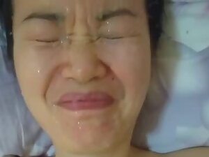 Funny cumshot on asian girl that hates cum