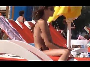 Topless girl reading and sunbathing Picture 7