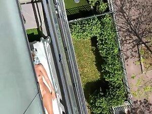Sexy neighbor suntans naked on her balcony Picture 3