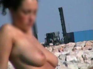 Nice brunette is topless at the beach - Voyeur Videos