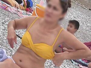 Sweet girl reads a book in doggy pose on the beach Picture 5