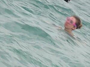 Sweet girl reads a book in doggy pose on the beach Picture 7