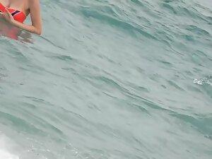 Sweet girl reads a book in doggy pose on the beach Picture 8