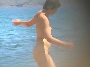 Mature nudist woman on the beach Picture 4