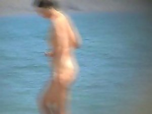 Mature nudist woman on the beach