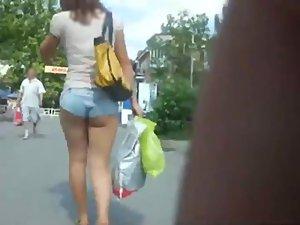 Creeping a girl with tucked in hot pants Picture 4