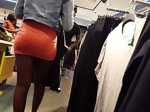 Mighty black booty in tight orange miniskirt Picture 2