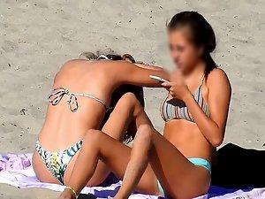 Two amazing teen girls bending over on beach