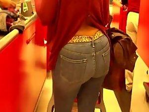 Mature woman's butt at a cash register