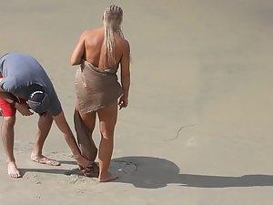 Strong naked woman with braided hair at beach Picture 1