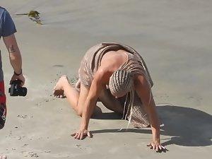 Strong naked woman with braided hair at beach Picture 3